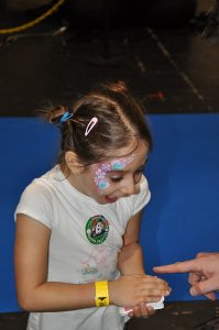 reaction shot of child at magic event
